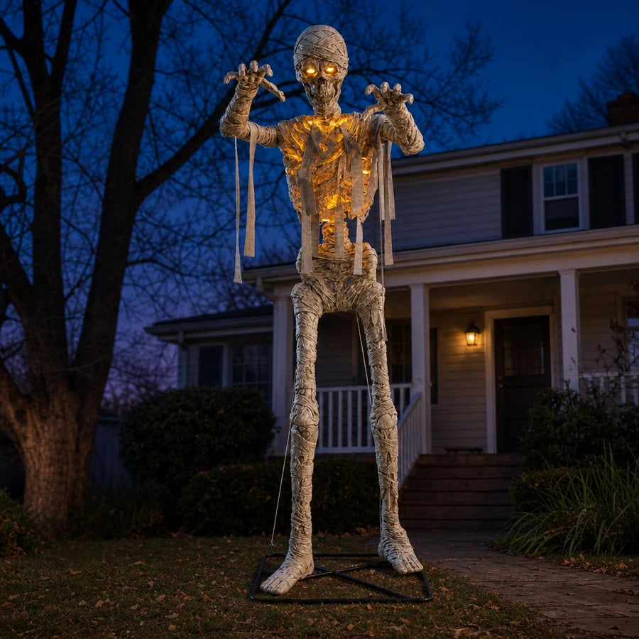Wide dusk shot of the mummy standing near the porch steps, clearing the roofline